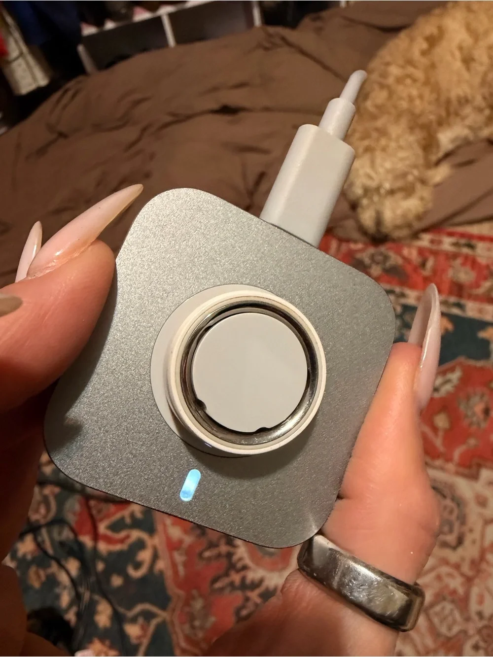 Oura Silver Smart Ring with White Charging Pad and Gray Cable